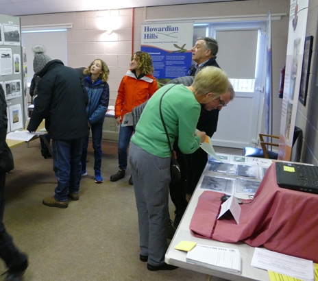 People looking at historical photos of the village